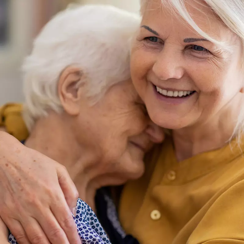 Senior Woman Embracing Older Woman