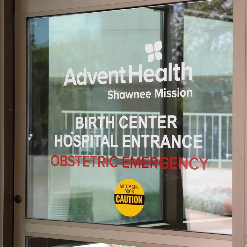 Glass door with AdventHealth Shawnee Mission logo and the words Birth Center Hospital Entrance Obstetric Emergency