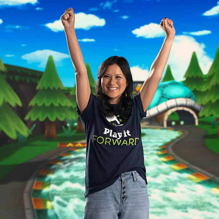 Mai Linh posing in front of a video game screen