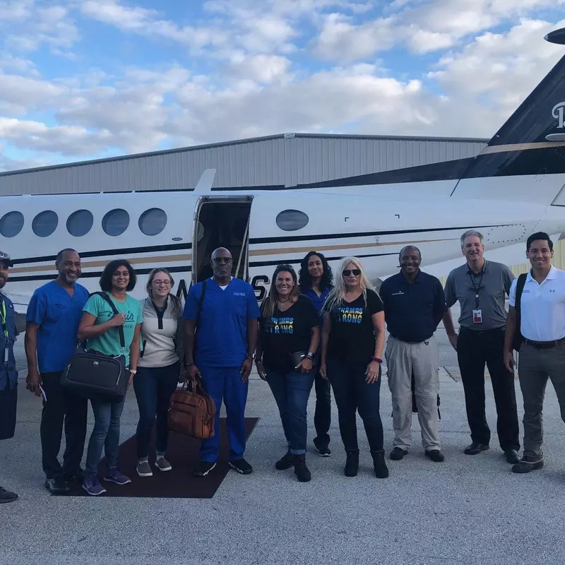 Bahamas recovery efforts team in front of airplane