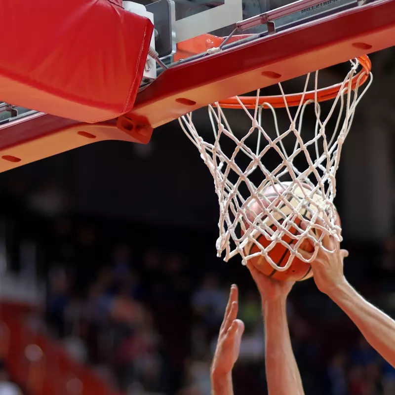 A basketball player dunking a ball.