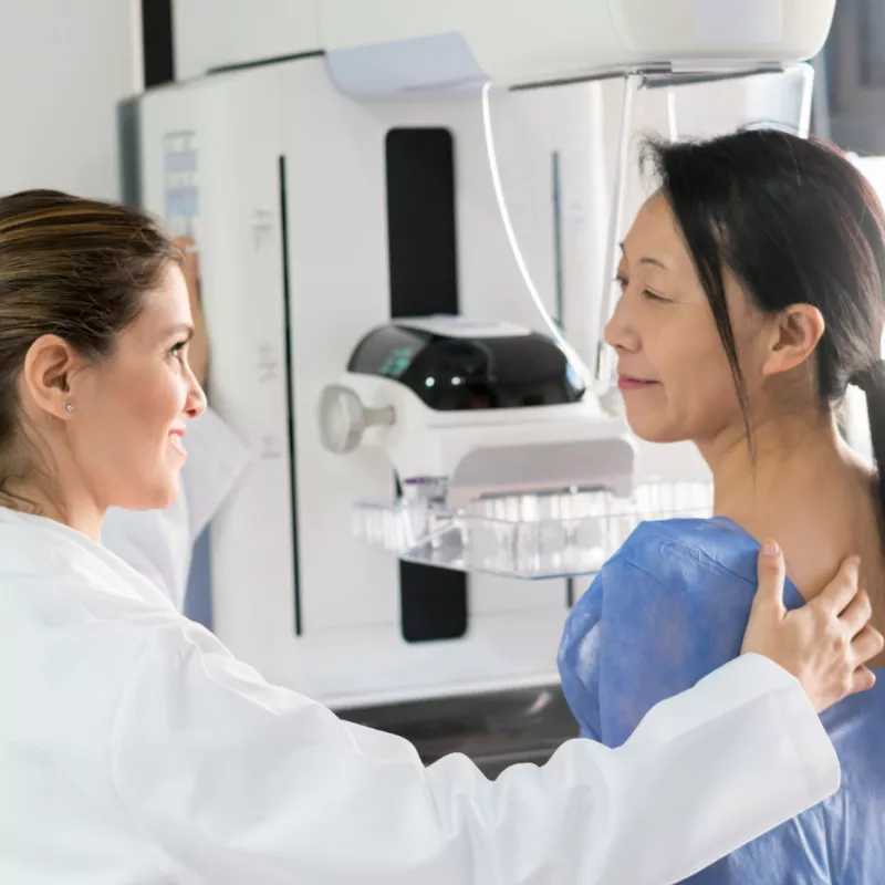 A woman about to receive a mammogram.