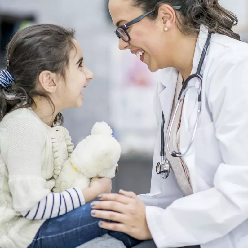 Child smiling at her doctor