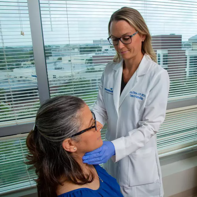 Dr. Cory O'Brien checking patient's throat at AdventHealth Digestive Health Institute Tampa.