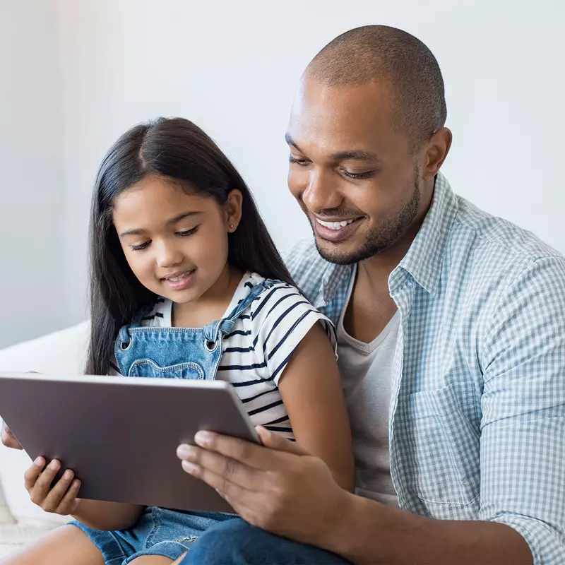 Dad and daughter reading tablet