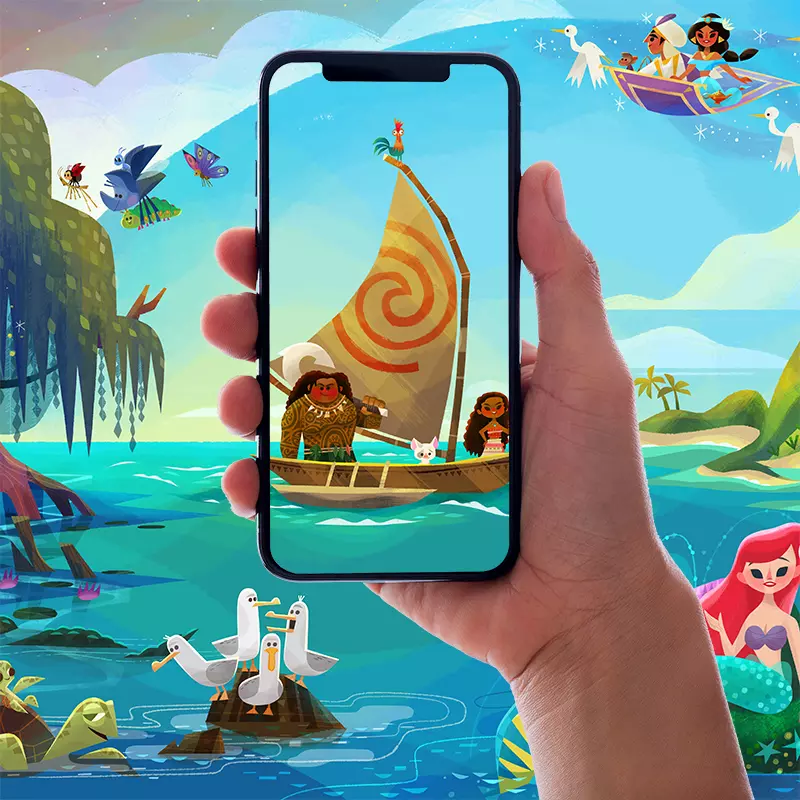Photo of a person holding up their phone to a magic mural featuring Moana and Maui.