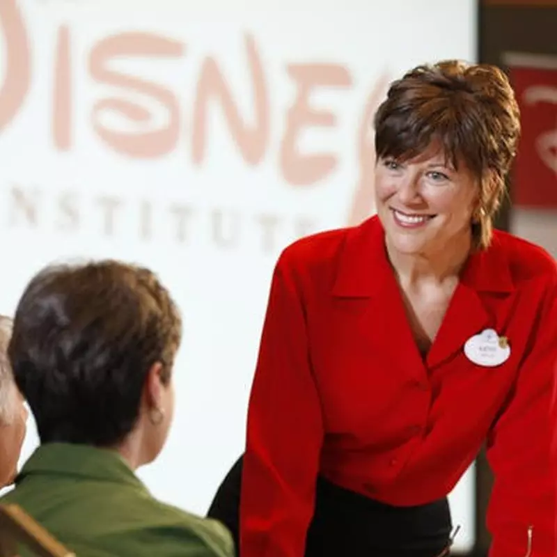 Disney institute employee speaking to a woman.