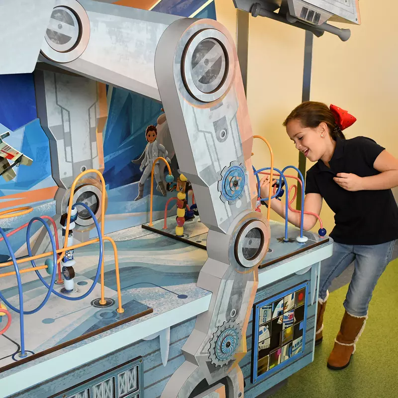 Girl playing with a Disney Team of Heroes Play Space at AdventHealth for Children.