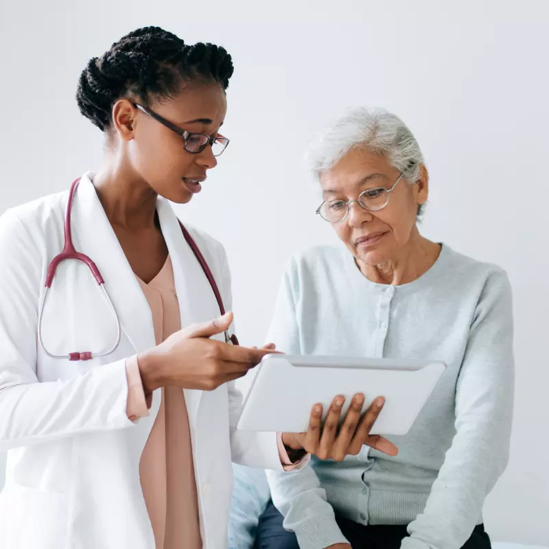 Doctor explaining to an older woman patient her test results.