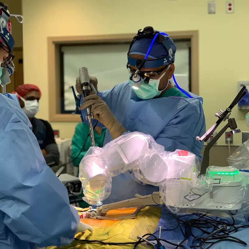 A doctor is using a robotic tool to conduct surgery.