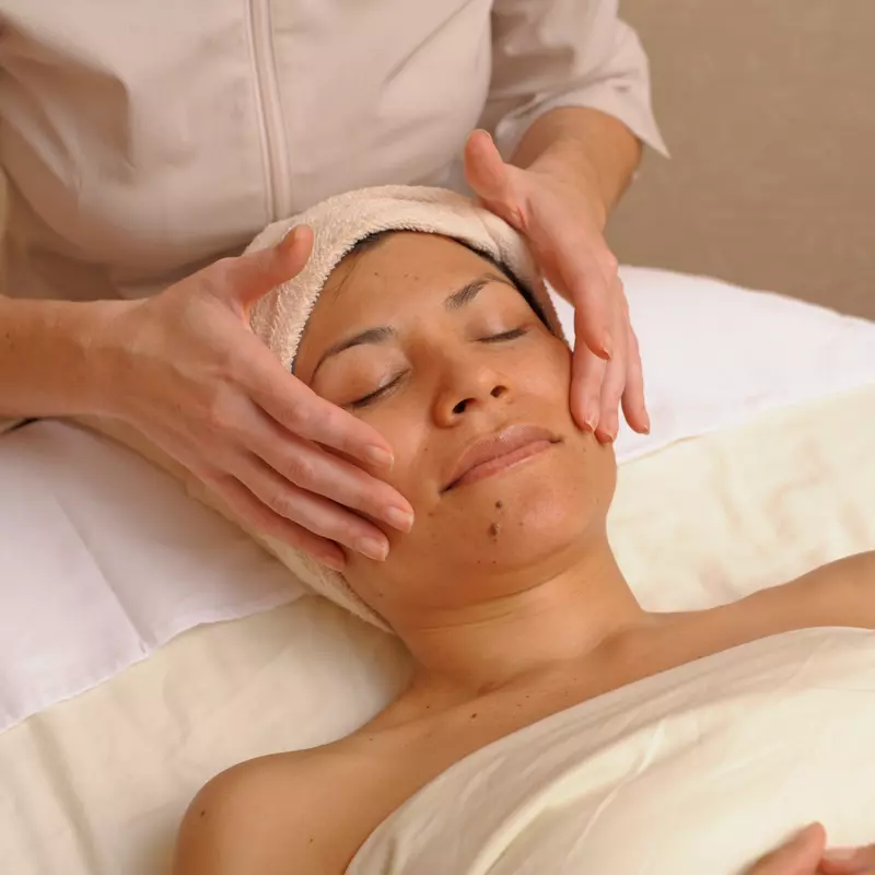 Woman getting a facial massage and relaxing.