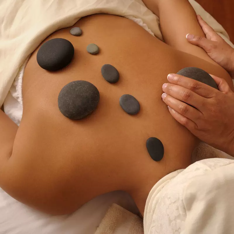 Woman getting a hot rock massage.