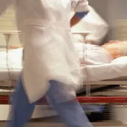 physician walking quickly with patient on a stretcher