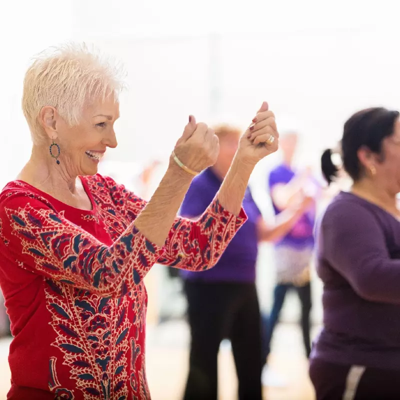 A group of older adults taking a dancing class.