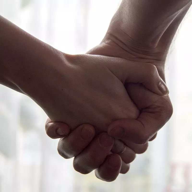 A close-up of two hands being held