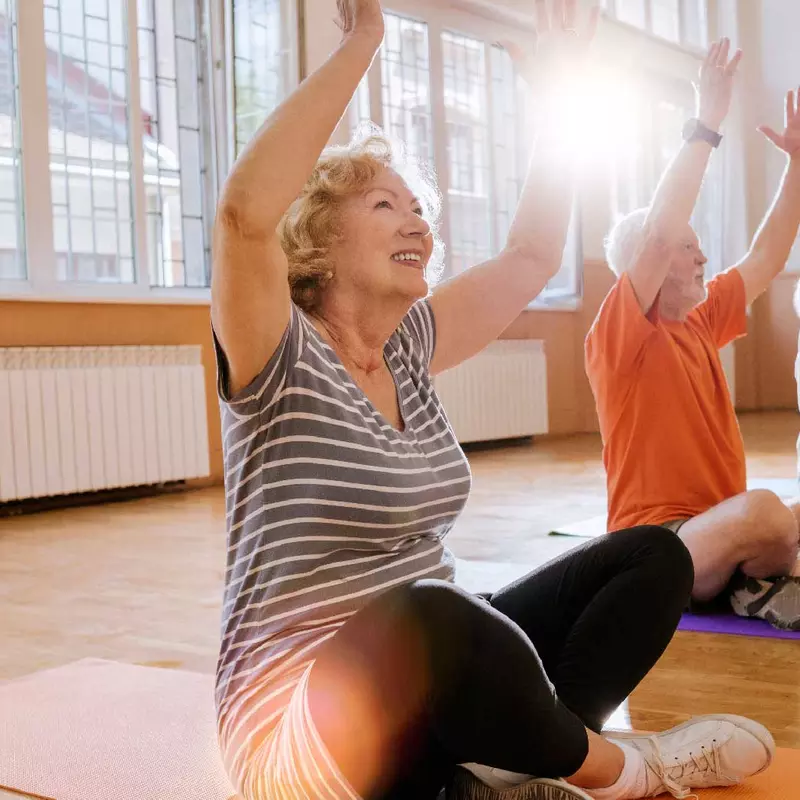 A group of seniors doing a yoga session