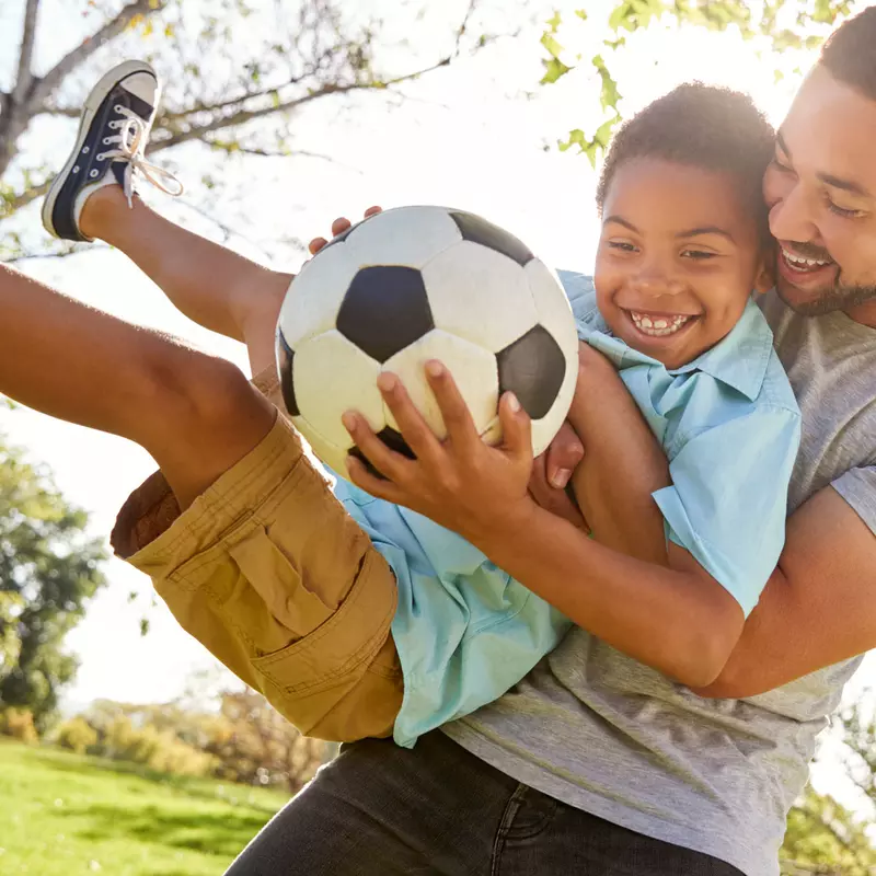 Father and Son with Soccer Ball outdoors