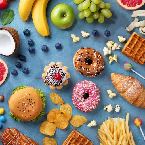 Different colorful foods, including bananas, coconuts, donuts, fries and more.
