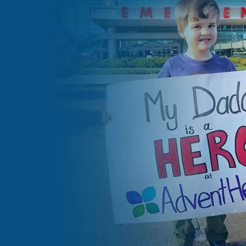 child holding sign outside hospital, AdventHealth Foundation COVID-19