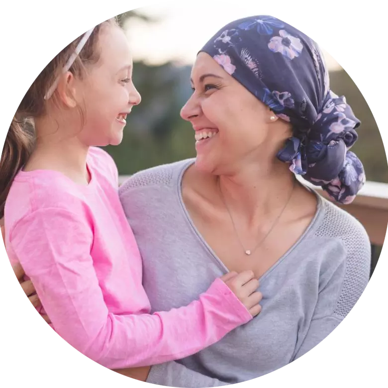 female cancer survivor holding daughter
