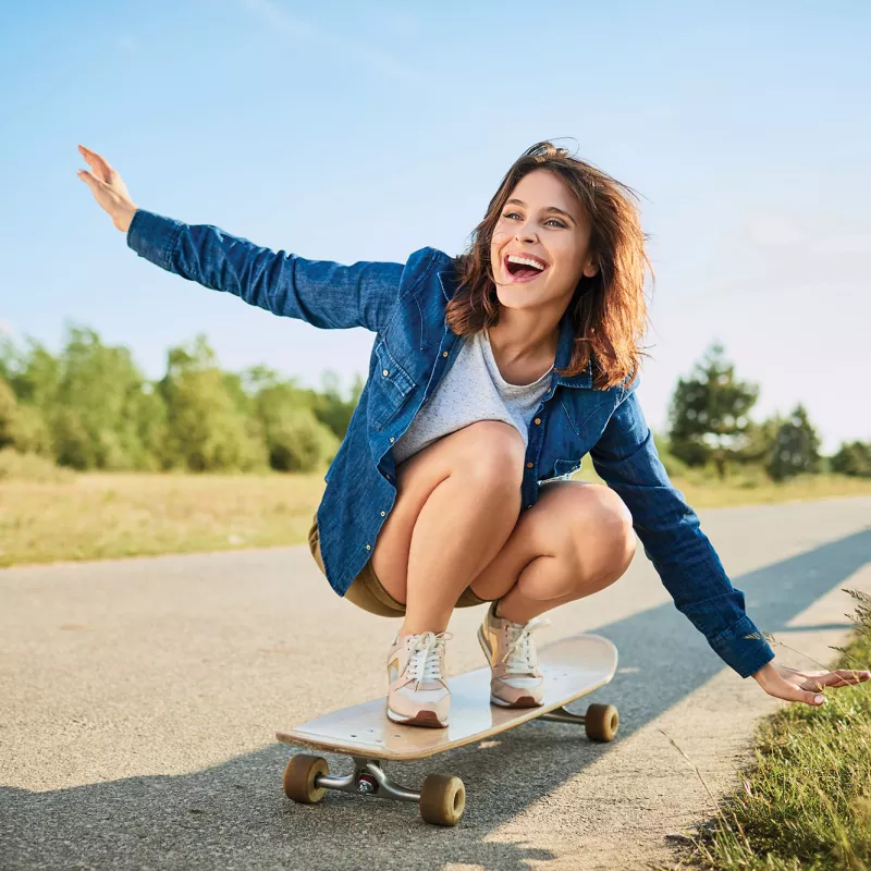 A young woman riding a skateboard.