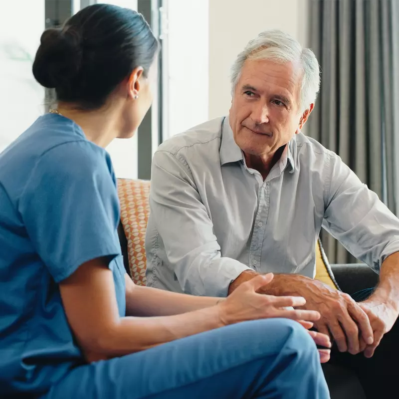 Nurse talking with older male patient