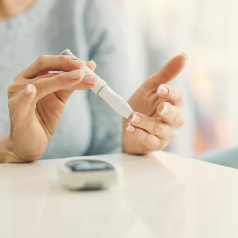 A Close Up of a Senior Person Checking Their Glucose with a Monitor