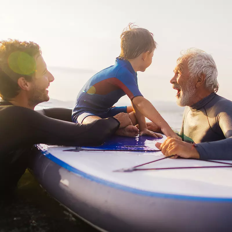 Son, father and grandfather in the ocean