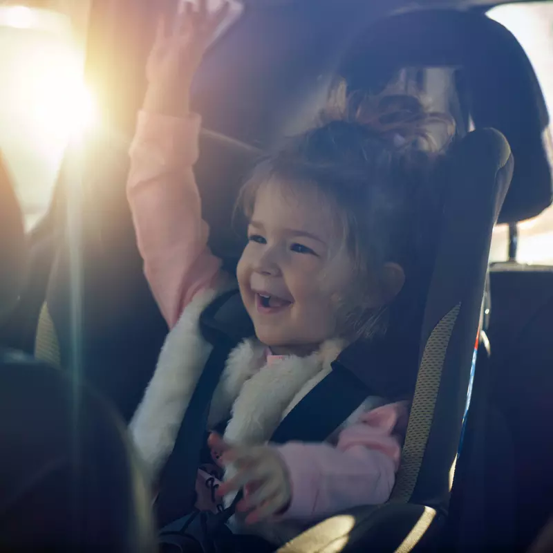 Child sitting in a child seat in a car
