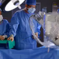 Surgeons conducting a robotic assisted surgery