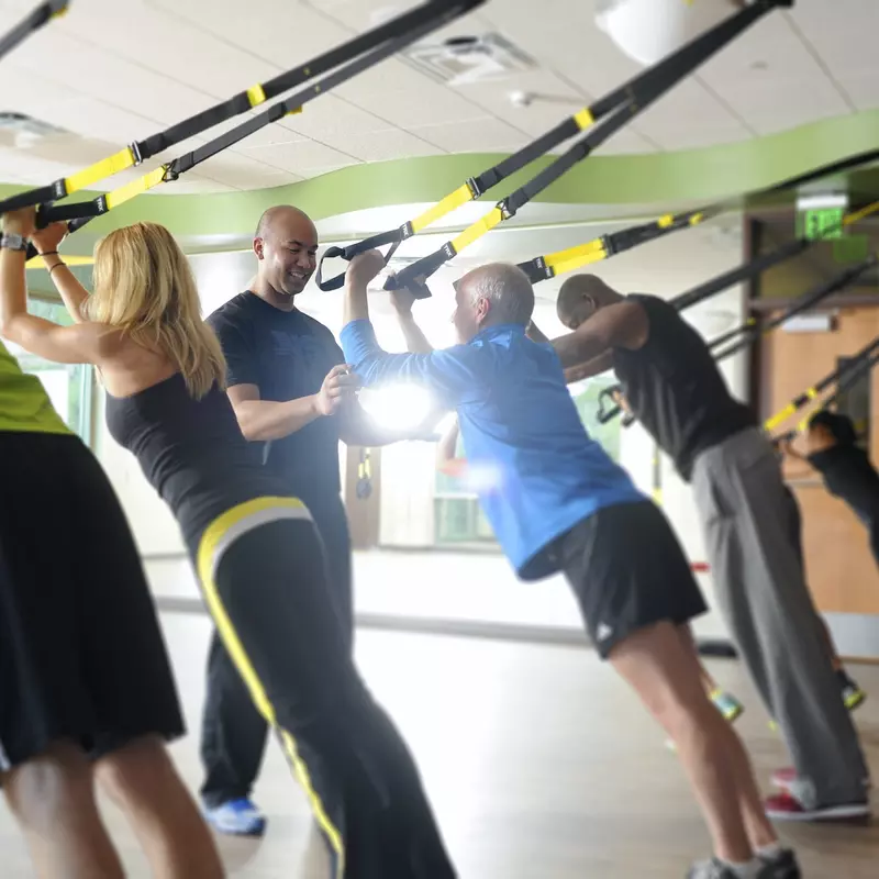 Indoor group exercise class and instructor using 