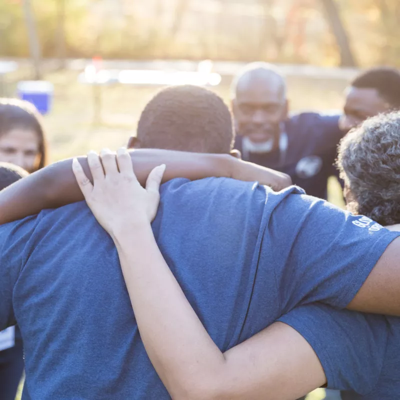 Group of people supporting each other outdoors 