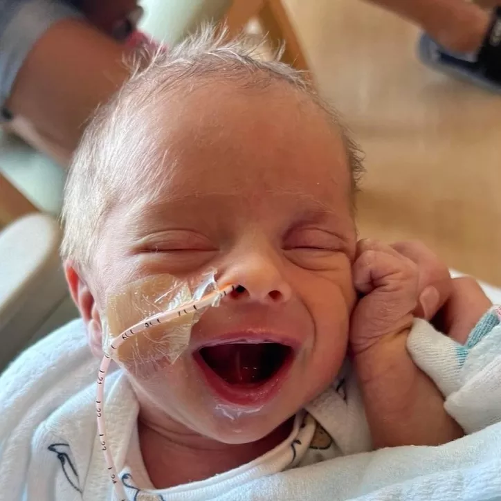 Baby Archer Hanson smiles at the camera from the NICU at AdventHealth Celebration.