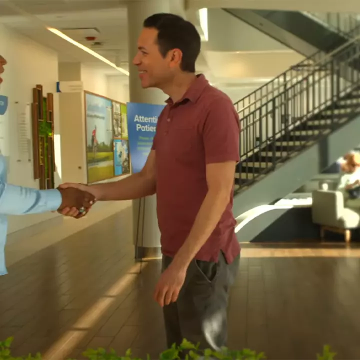 A patient shakes hands with an AdventHealth employee at a Health park facility.