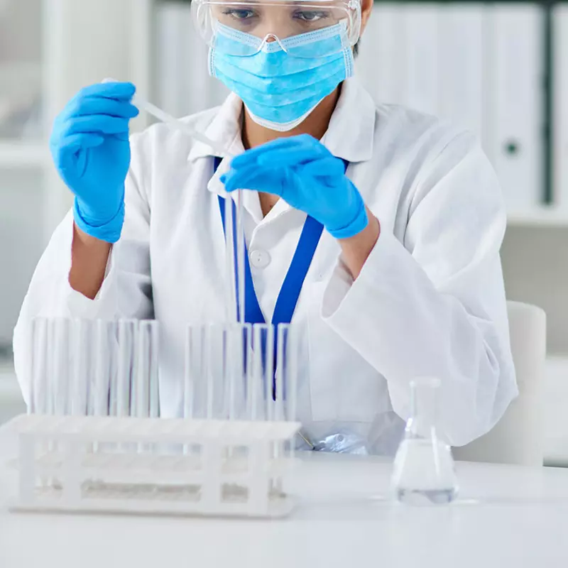 A lab technician working in the lab. 