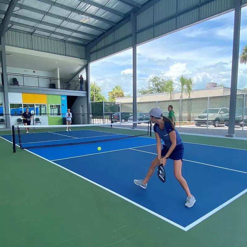 Two pairs of ladies playing pickle ball