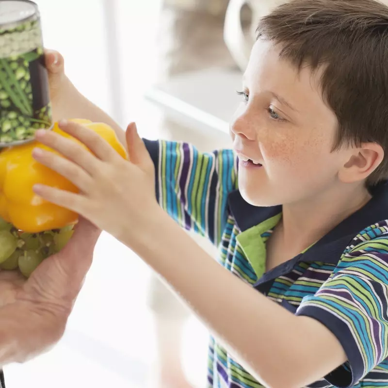 A boy discovering new types of vegetables. 