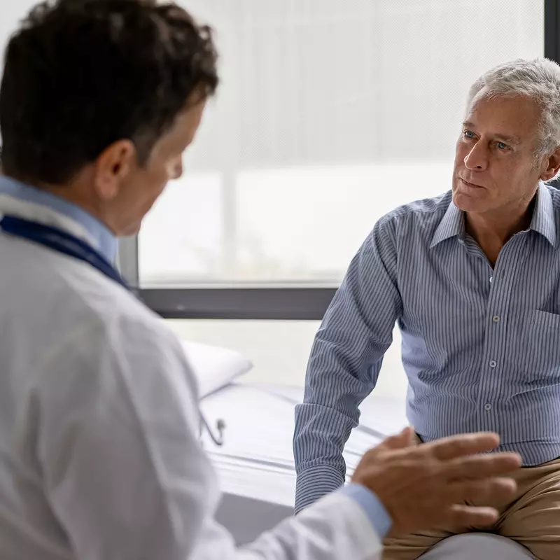 A Doctor Speaks to His Senior Patient About His Treatment Plan in an Exam Room