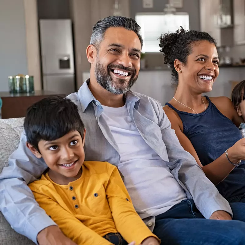 Family watching television at home together.