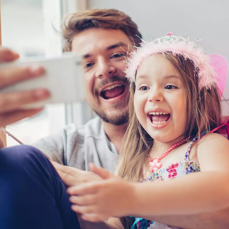 A father and daughter stay connected with a video call.