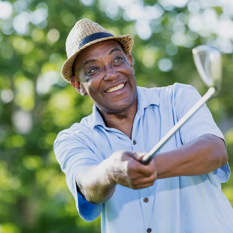 A man swinging a golf club.