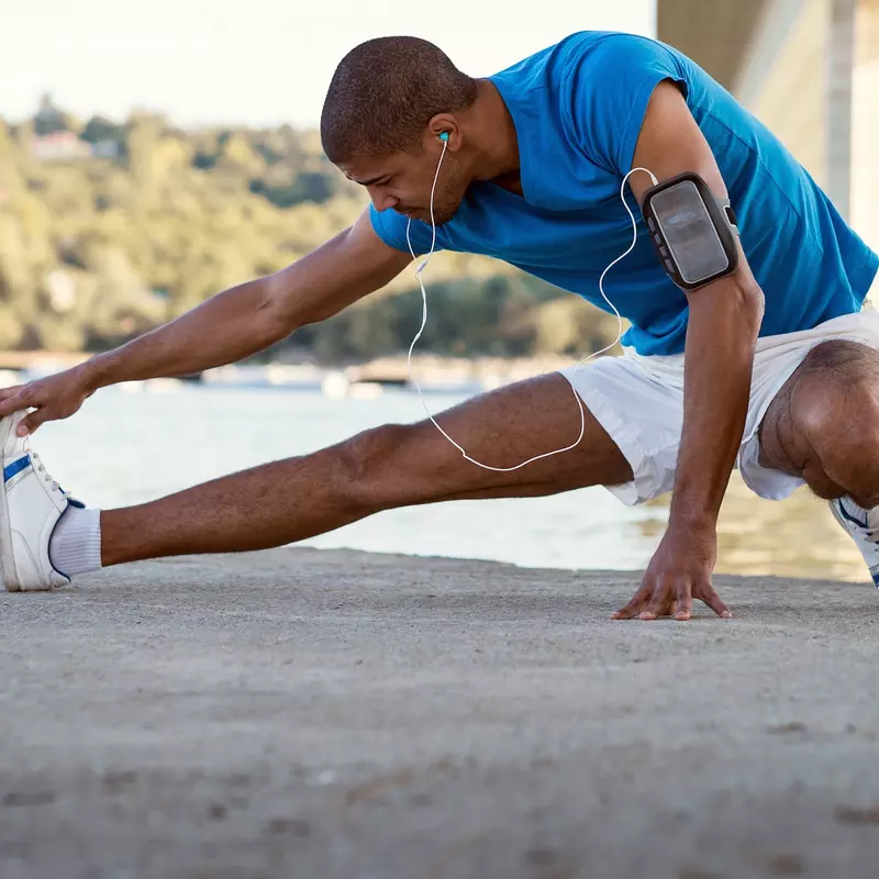 A man stretching after a run. 