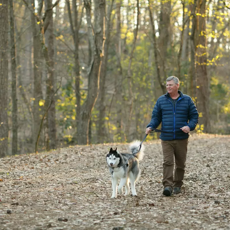 Mark and his dog walking in the woods