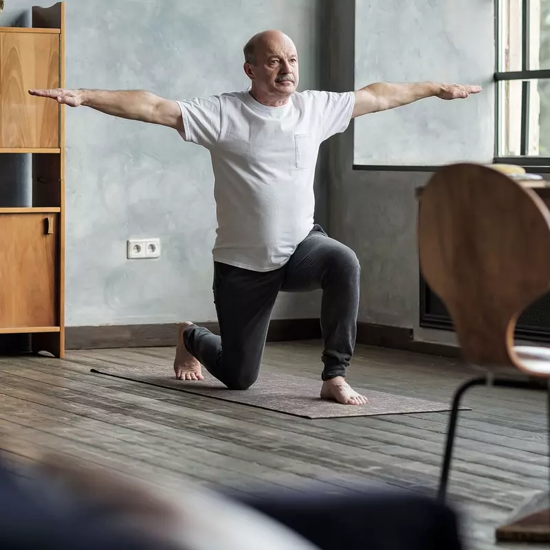A older man stretching at home.