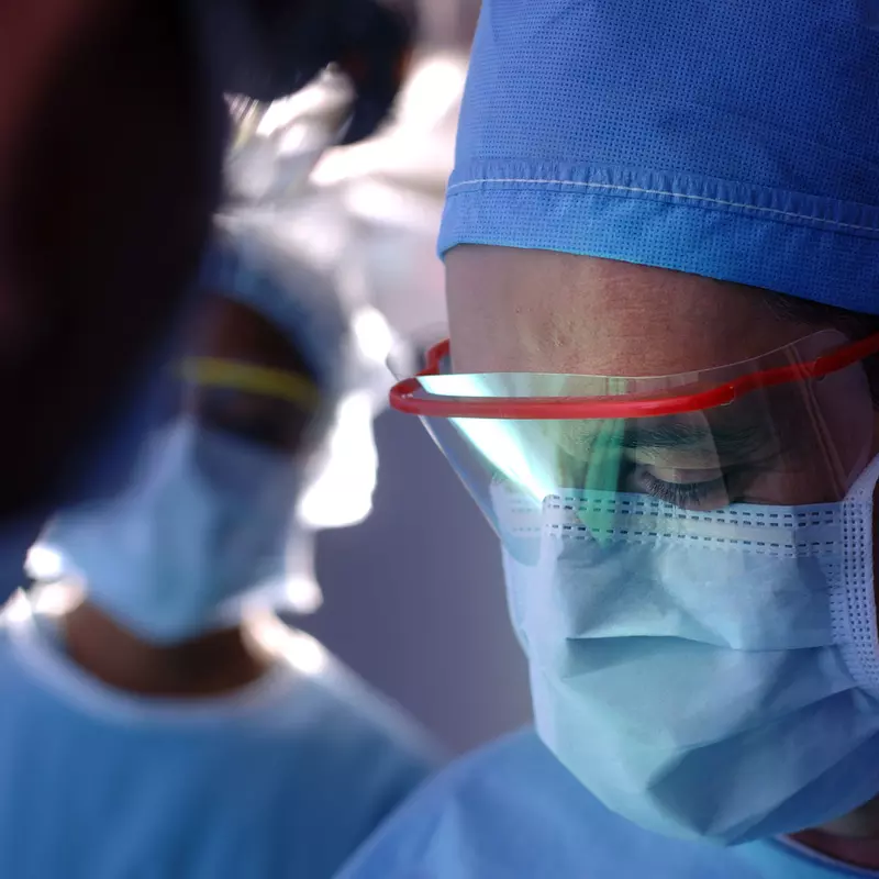 A team of physicians in the middle of a surgery