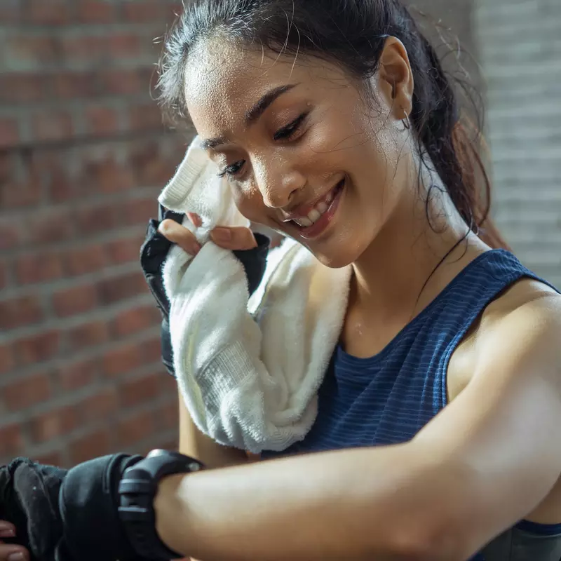 A runner takes a break to check her heart rate.