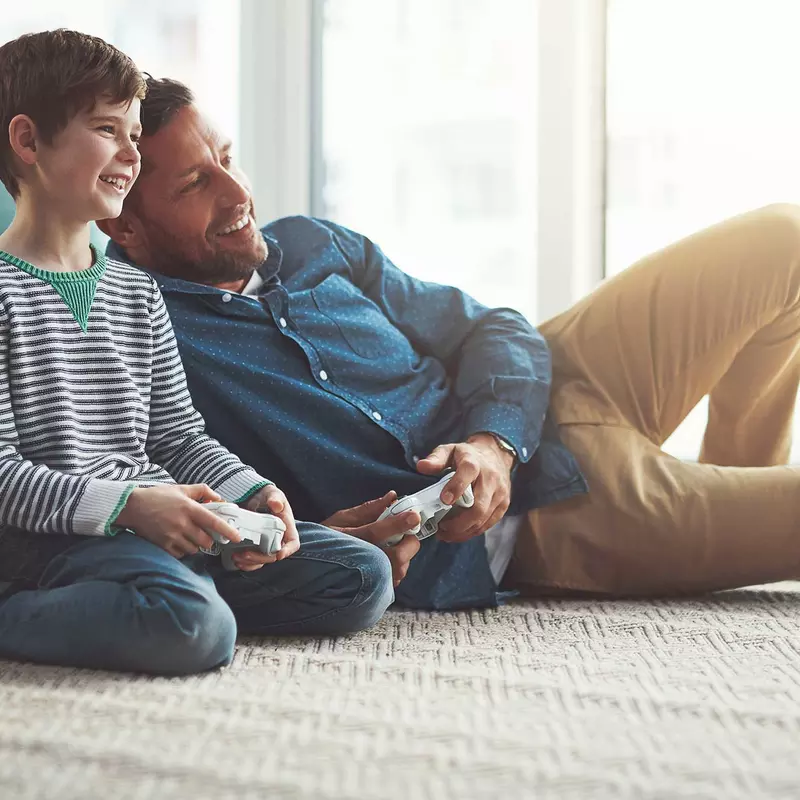 A father and son playing video games.