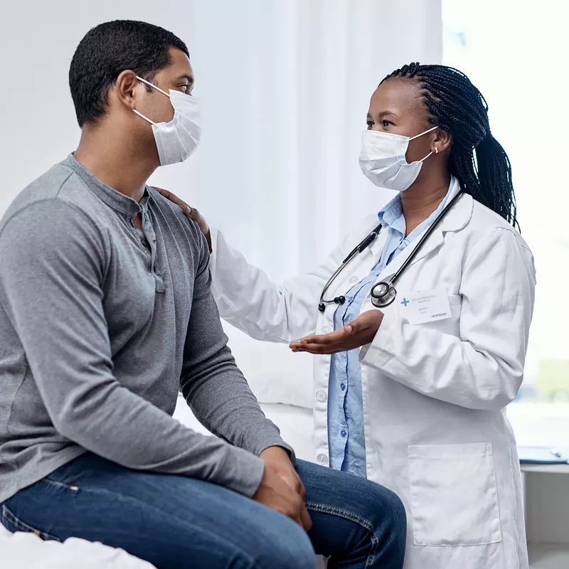 A physician discussing something to her patient