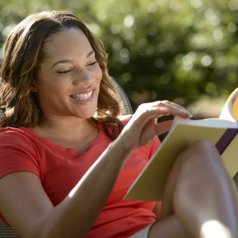 A woman reading outdoors.