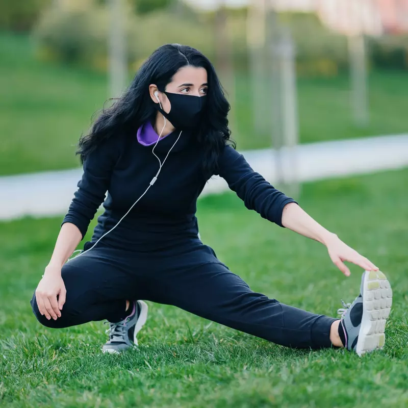 A woman stretching before she exercises